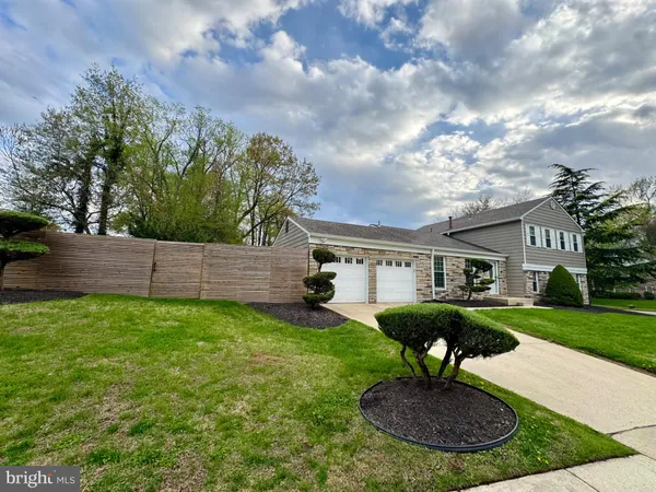 a front view of house with a garden