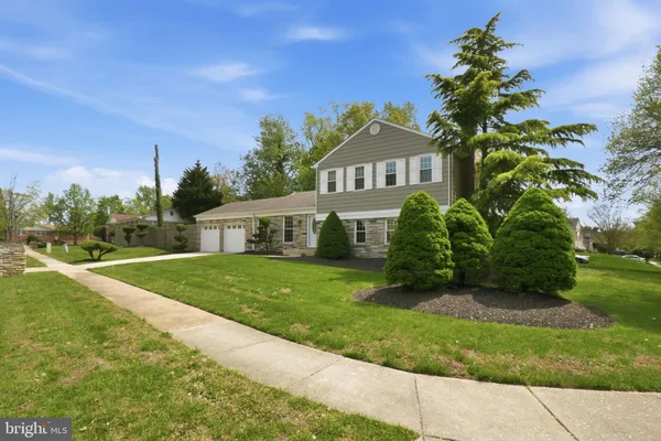 a kitchen with stainless steel appliances granite countertop a stove a sink a refrigerator and a microwave