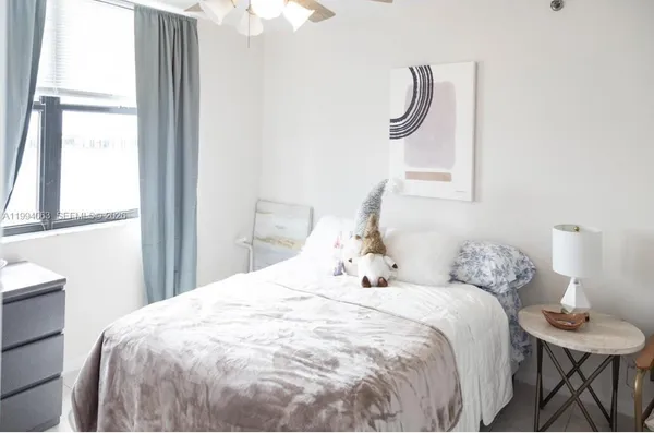 a bedroom with a bed and a table with chair
