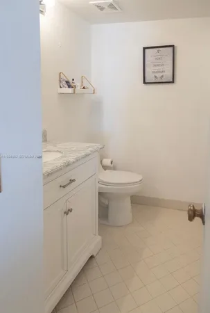 a bathroom with a toilet sink and vanity