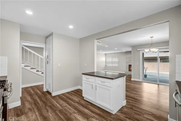 a kitchen with a stove a sink and a refrigerator