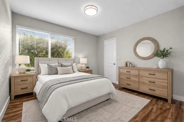 a bath room with a toilet a sink and a mirror