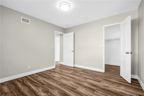 a view of a room with wooden floor and a window