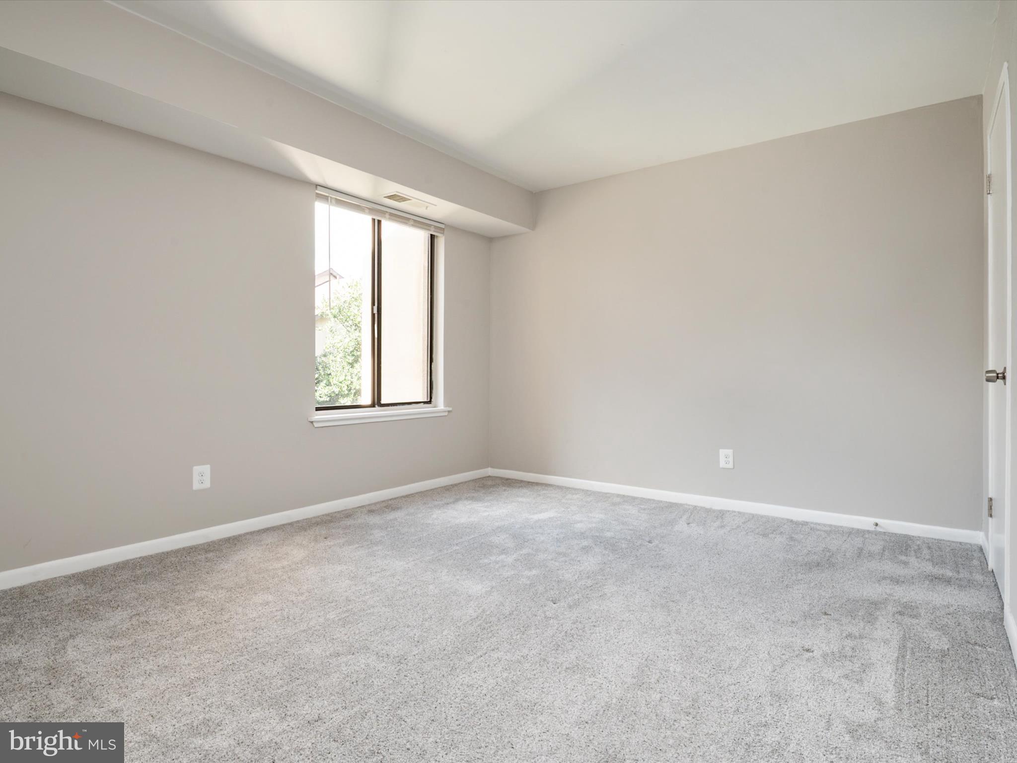 9639 White Acre Road, Unit B1 Columbia, MD 21045 - Photo 15 of 23 an empty room with windows and closet