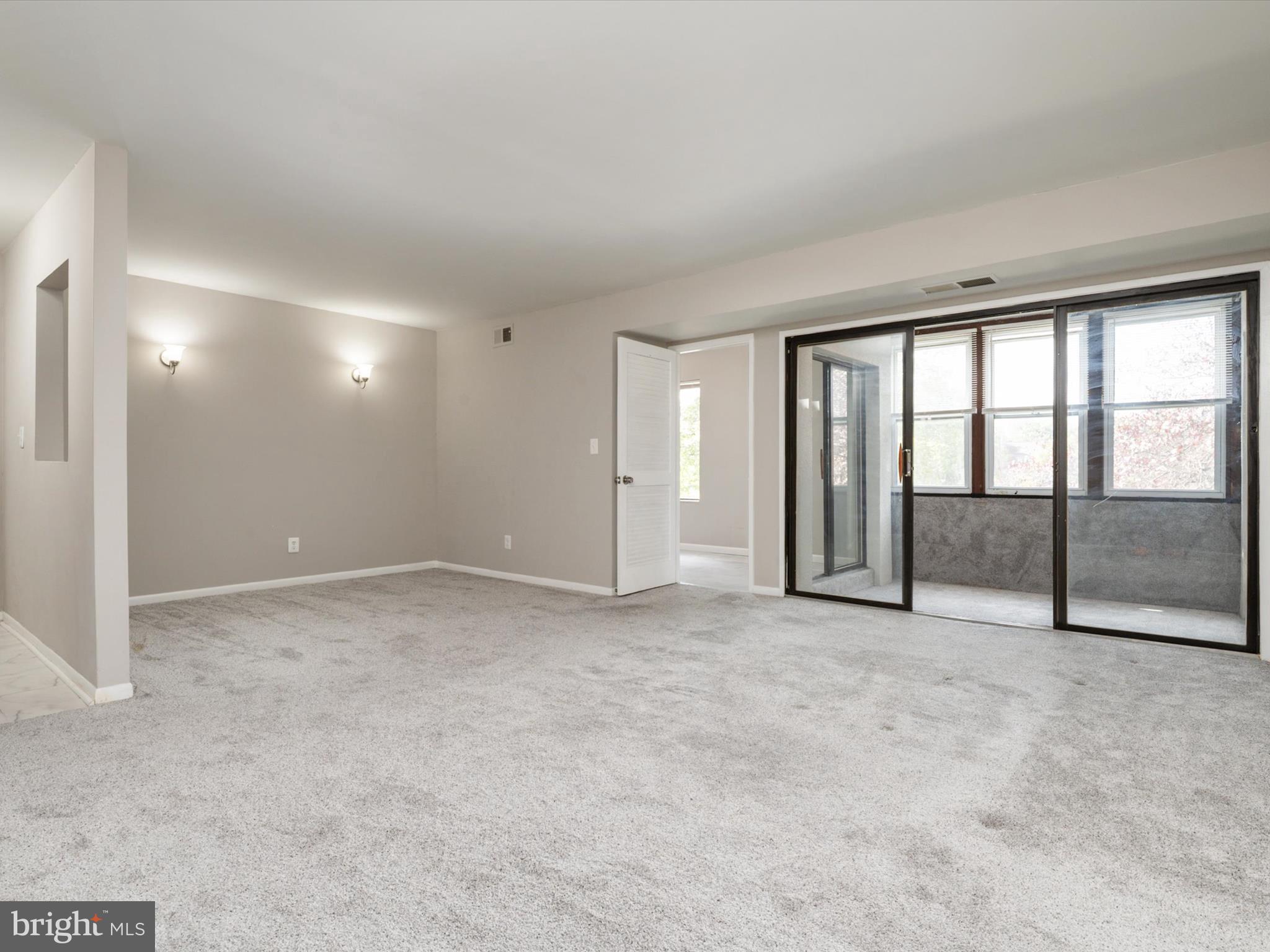 9639 White Acre Road, Unit B1 Columbia, MD 21045 - Photo 7 of 23 a view of an empty room with a window