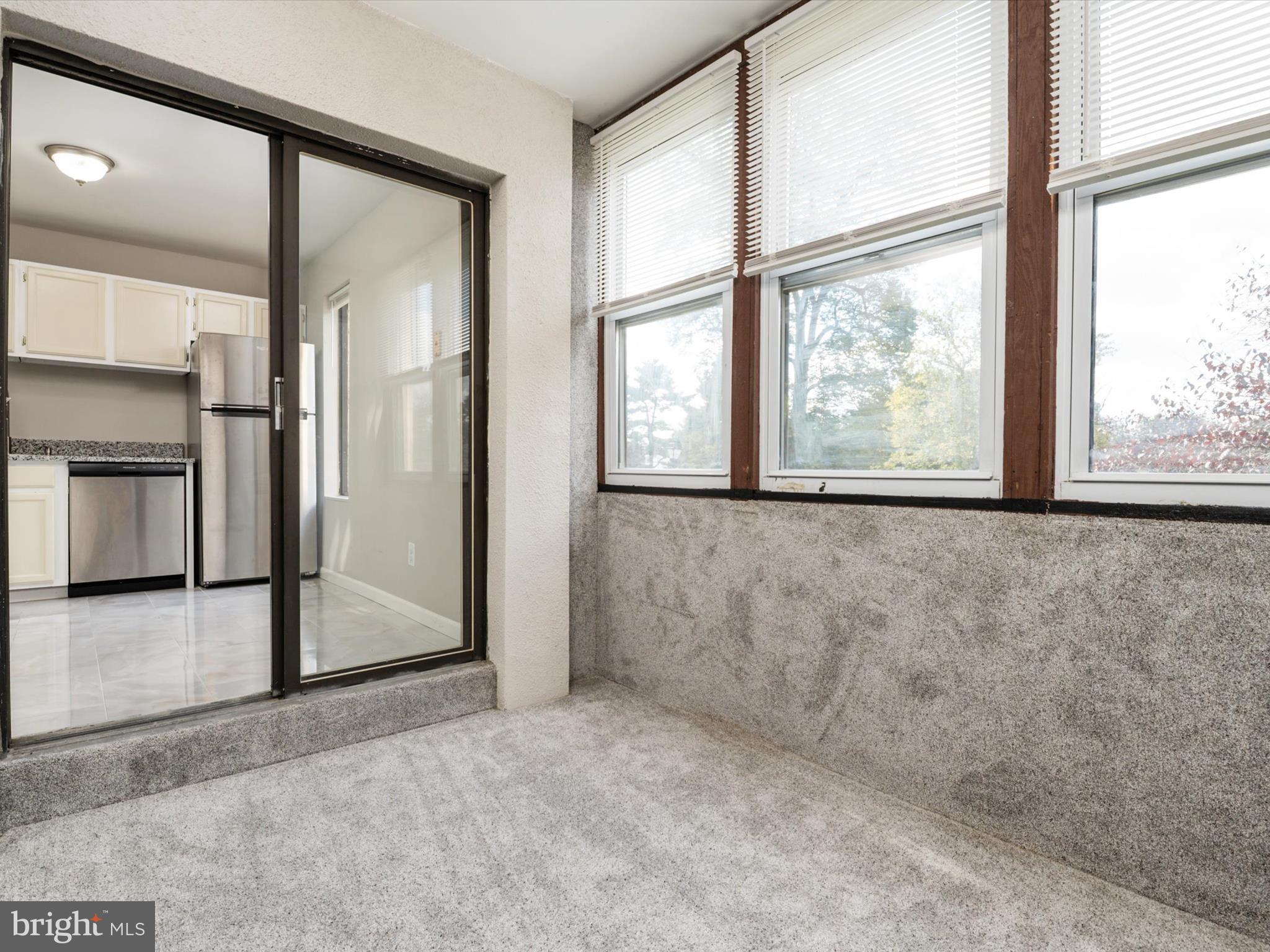 9639 White Acre Road, Unit B1 Columbia, MD 21045 - Photo 10 of 23 an empty room with large window