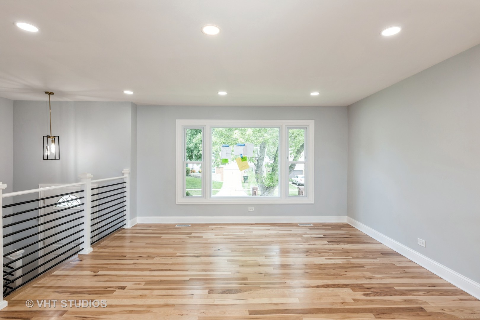 5657 Dover Road Oak Forest, IL 60452 - Photo 3 of 20 an empty room with wooden floor and windows