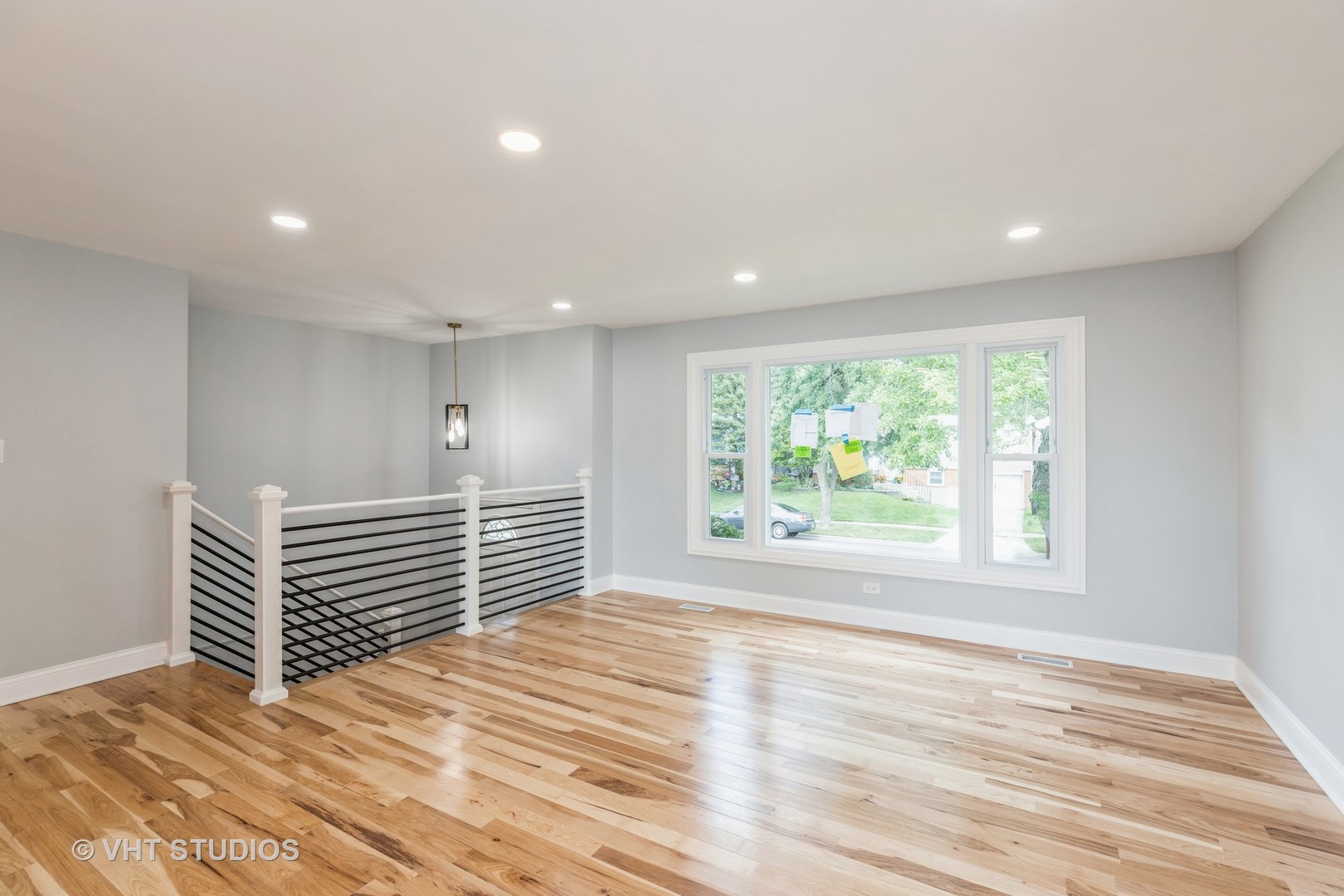 5657 Dover Road Oak Forest, IL 60452 - Photo 4 of 20 a view of an empty room with wooden floor and a window