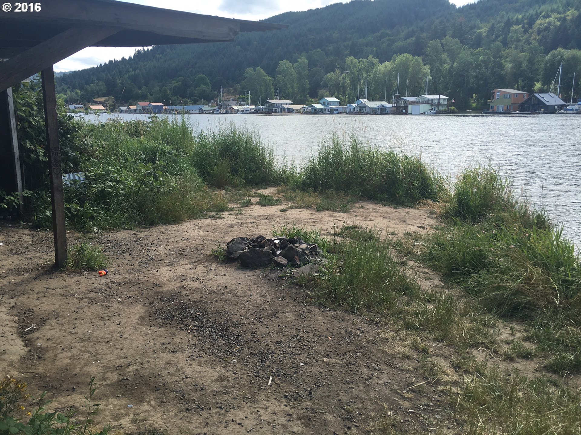 24514 Northwest Sauvie Island Road Portland, OR 97231 - Photo 7 of 16 a backyard of a house with lots of green space and lake view
