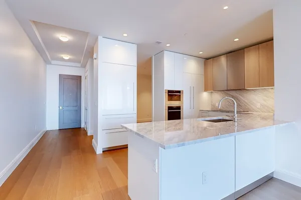 a view of a kitchen with a sink and cabinets