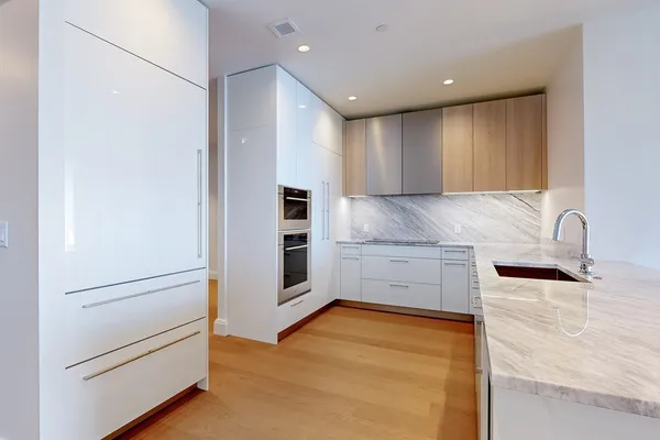 a view of kitchen with cabinet and refrigerator