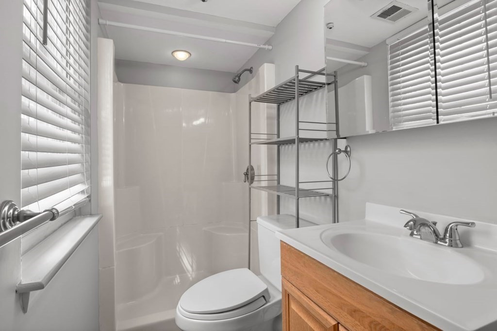 33 Christopher Drive, Unit A Stoughton, MA 02072 - Photo 15 of 23 a bathroom with a sink a toilet and shower