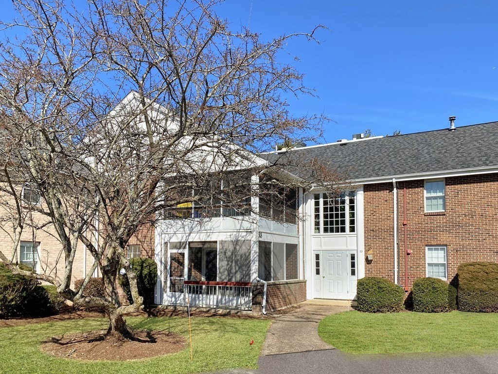 33 Christopher Drive, Unit A Stoughton, MA 02072 - Photo 2 of 23 a front view of a house with garden