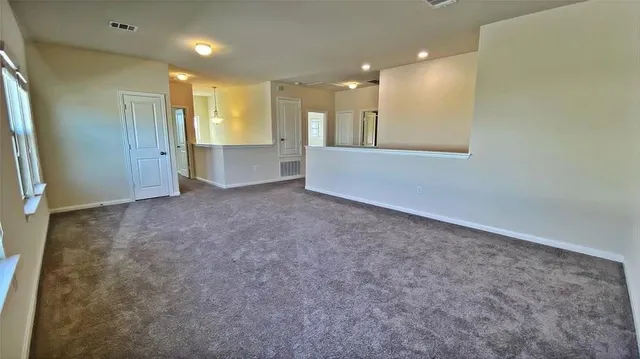 an empty room with a empty space and windows