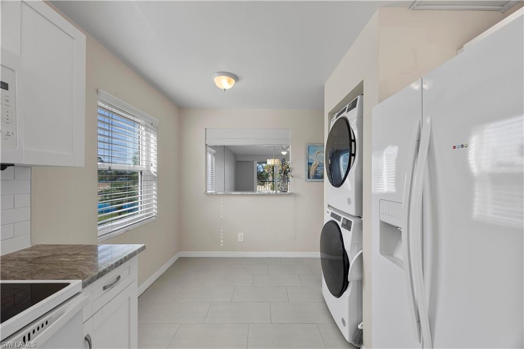 4372 27th Court Southwest, Unit 301 Naples, FL 34116 - Photo 14 of 37 a utility room with dryer and washer