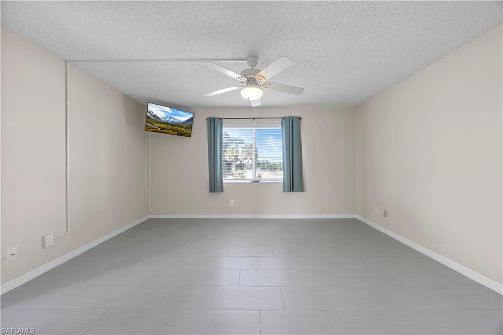 4372 27th Court Southwest, Unit 301 Naples, FL 34116 - Photo 23 of 37 wooden floor in an empty room with a window