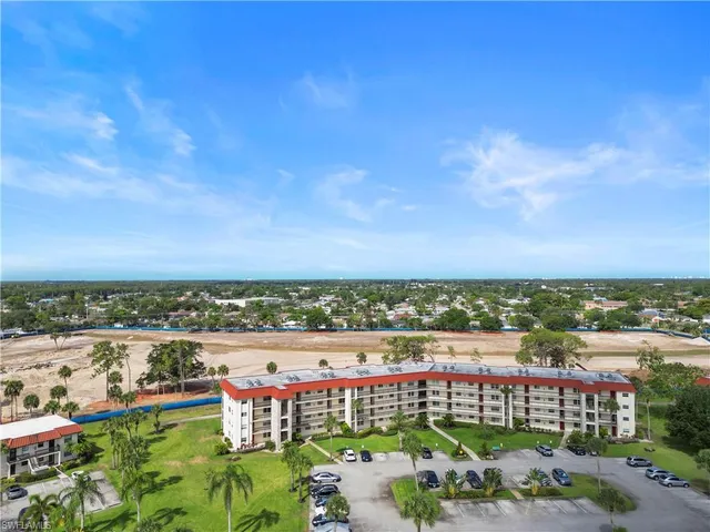 a view of a city with an apartment building in the background