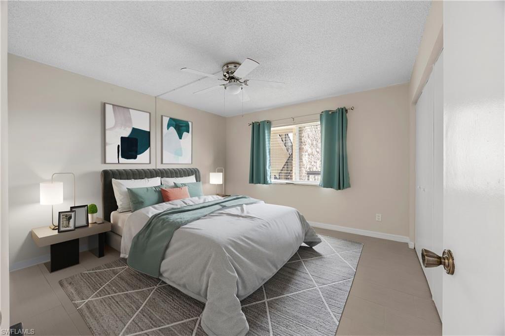 4372 27th Court Southwest, Unit 301 Naples, FL 34116 - Photo 7 of 37 a bedroom with a large bed and a window