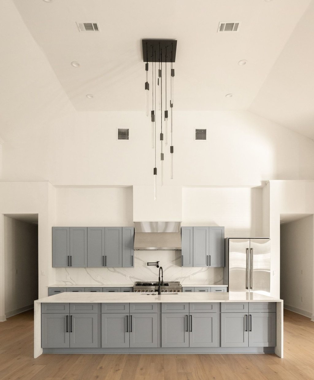 Undisclosed Address Austin, TX 78751 - Photo 4 of 20 The kitchen is a true centerpiece in the home, featuring modern finishes and a statement light fixture to center the room.