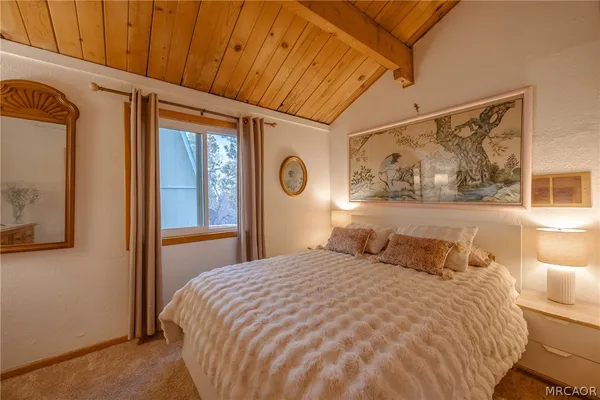 a bedroom with a large bed and a window