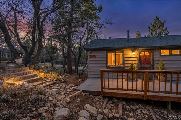 a view of a house with backyard and sitting area