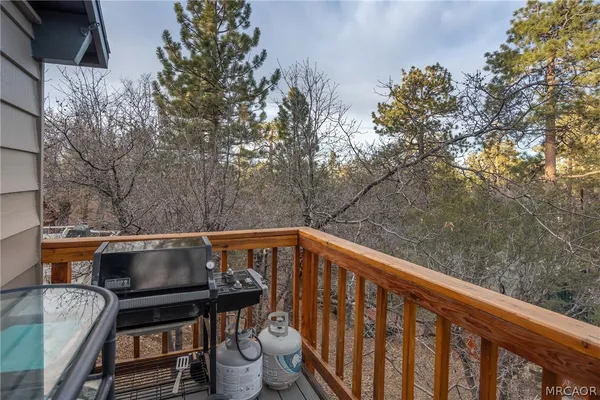 a view of a balcony with mountain view and wooden floor