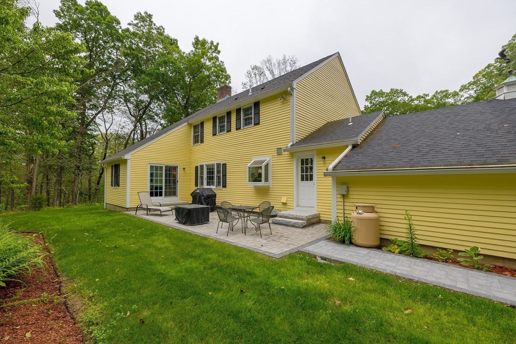 759 Main Street Boxford, MA 01921 - Photo 3 of 35 a view of a patio with table and chairs and wooden fence