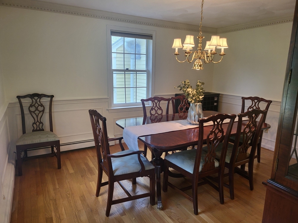 759 Main Street Boxford, MA 01921 - Photo 7 of 35 a dining room with furniture a chandelier and wooden floor