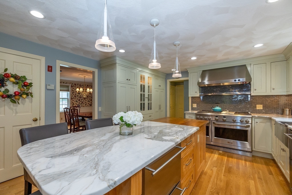 759 Main Street Boxford, MA 01921 - Photo 8 of 35 a kitchen with stainless steel appliances granite countertop a sink a stove and a wooden floors