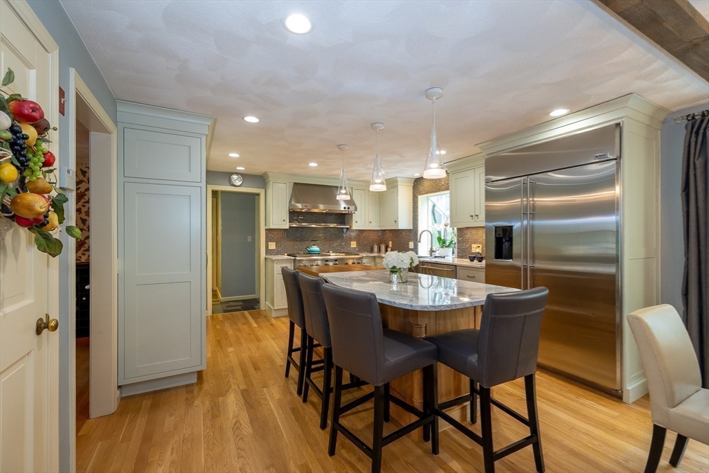 759 Main Street Boxford, MA 01921 - Photo 9 of 35 a dining area with stainless steel appliances kitchen island granite countertop a dining table chairs and a refrigerator