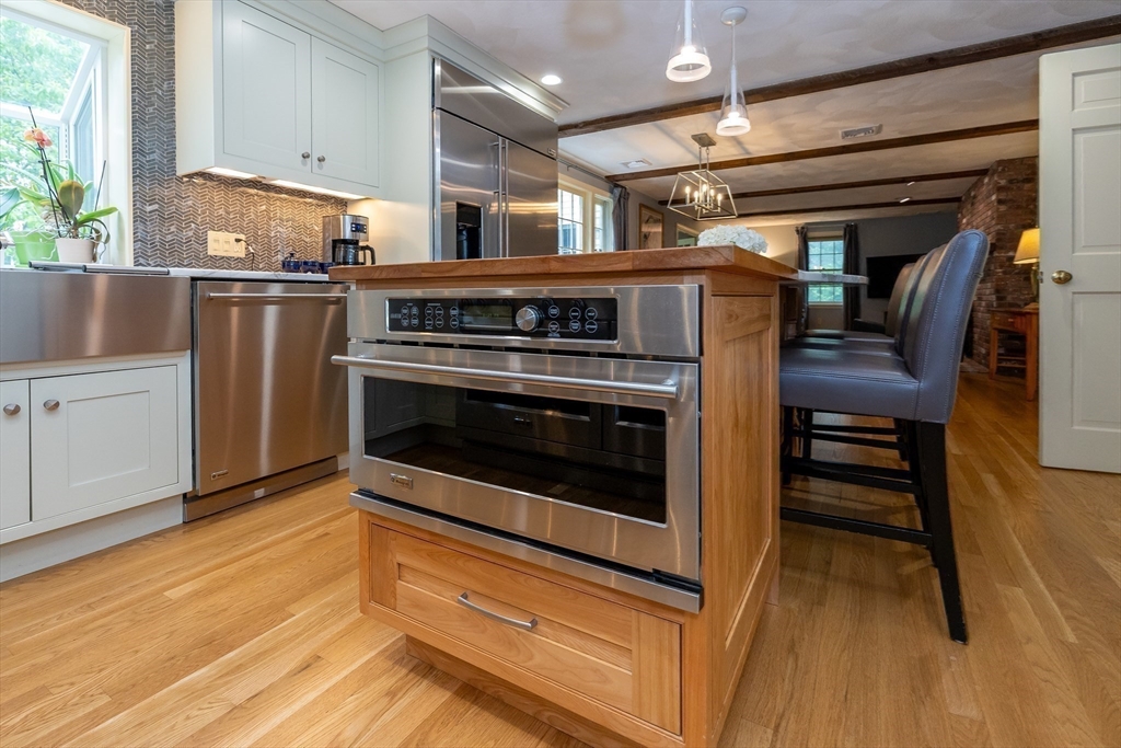 759 Main Street Boxford, MA 01921 - Photo 10 of 35 a kitchen with kitchen island a stove and a wooden floors