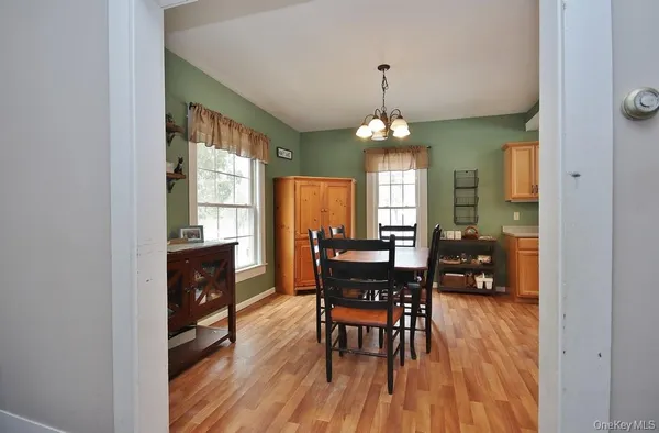 a view of a dining room with furniture and window