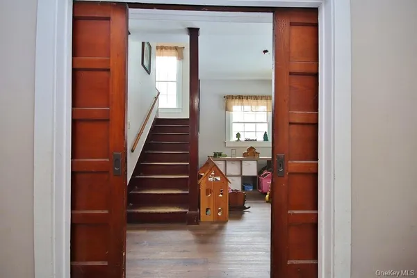 a view of entryway and hall with wooden floor