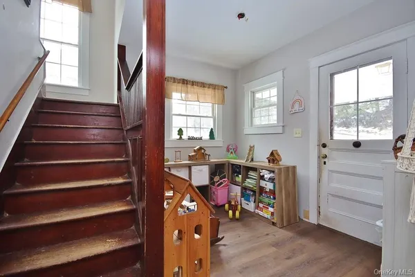 a view of a workspace with furniture and a window