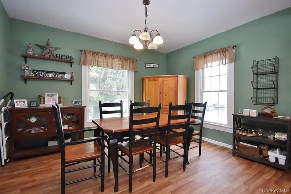 a view of a dining room with furniture window and wooden floor