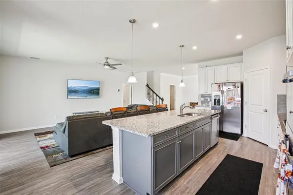 a kitchen with stainless steel appliances granite countertop a stove and a refrigerator