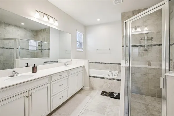 a bathroom with a shower sink and mirror