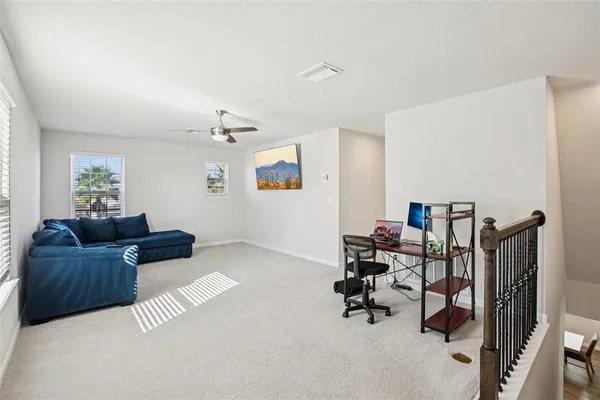 a living room with furniture and a gym machine