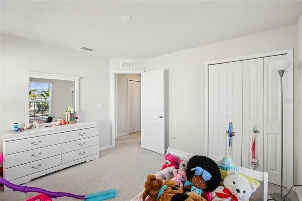 a bed room with a bed and a mirror