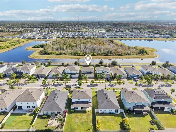 an aerial view of residential houses with outdoor space