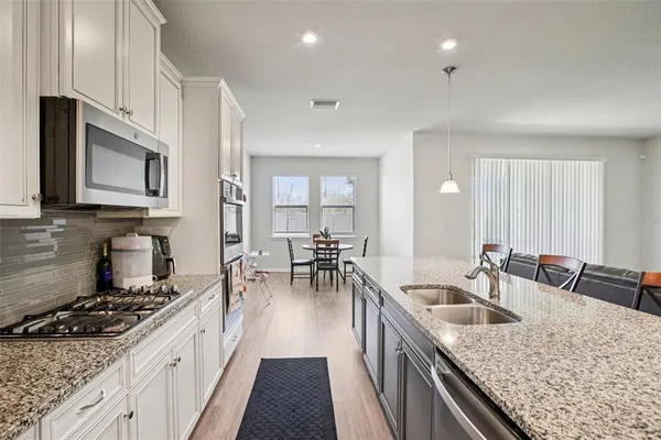 a kitchen with sink stove and cabinets