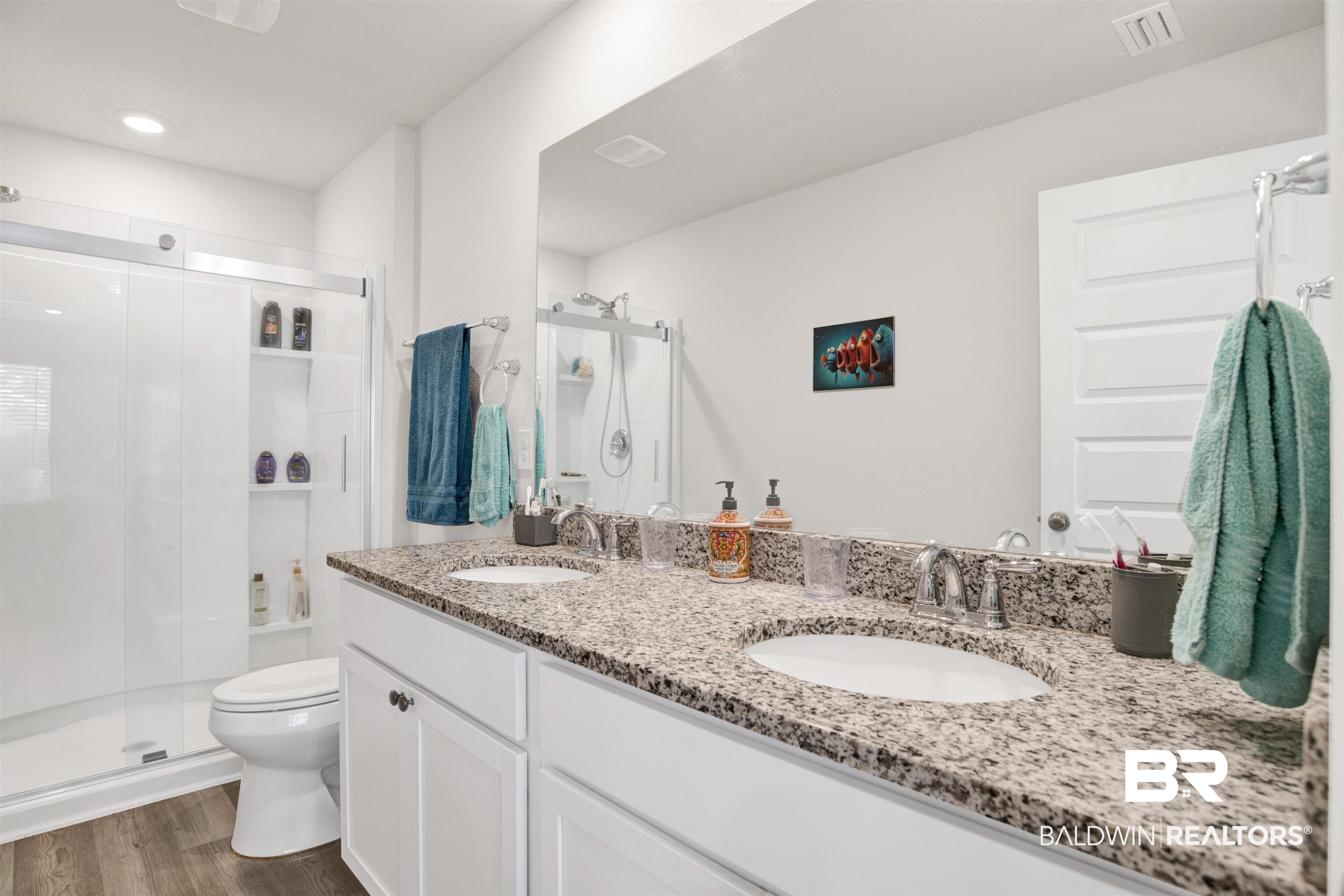 22348 Aleutian Avenue Foley, AL 36535 - Photo 16 of 32 Full bath with double vanity, a shower stall, and dark wood finished floors