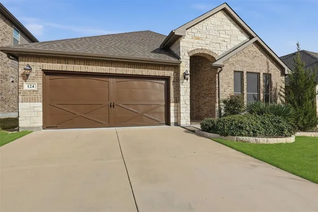 a view of a house with a yard and garage