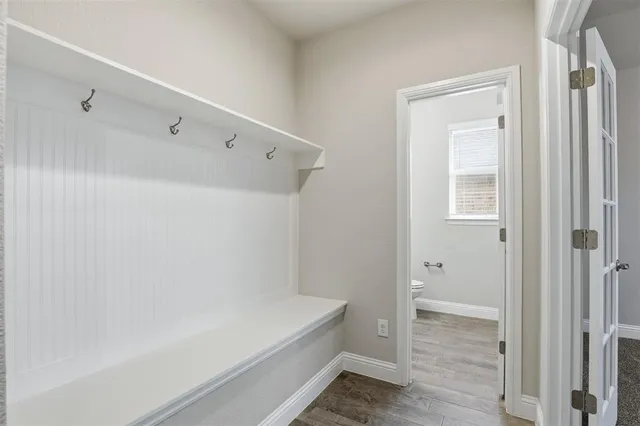 a kitchen with white cabinets and appliances