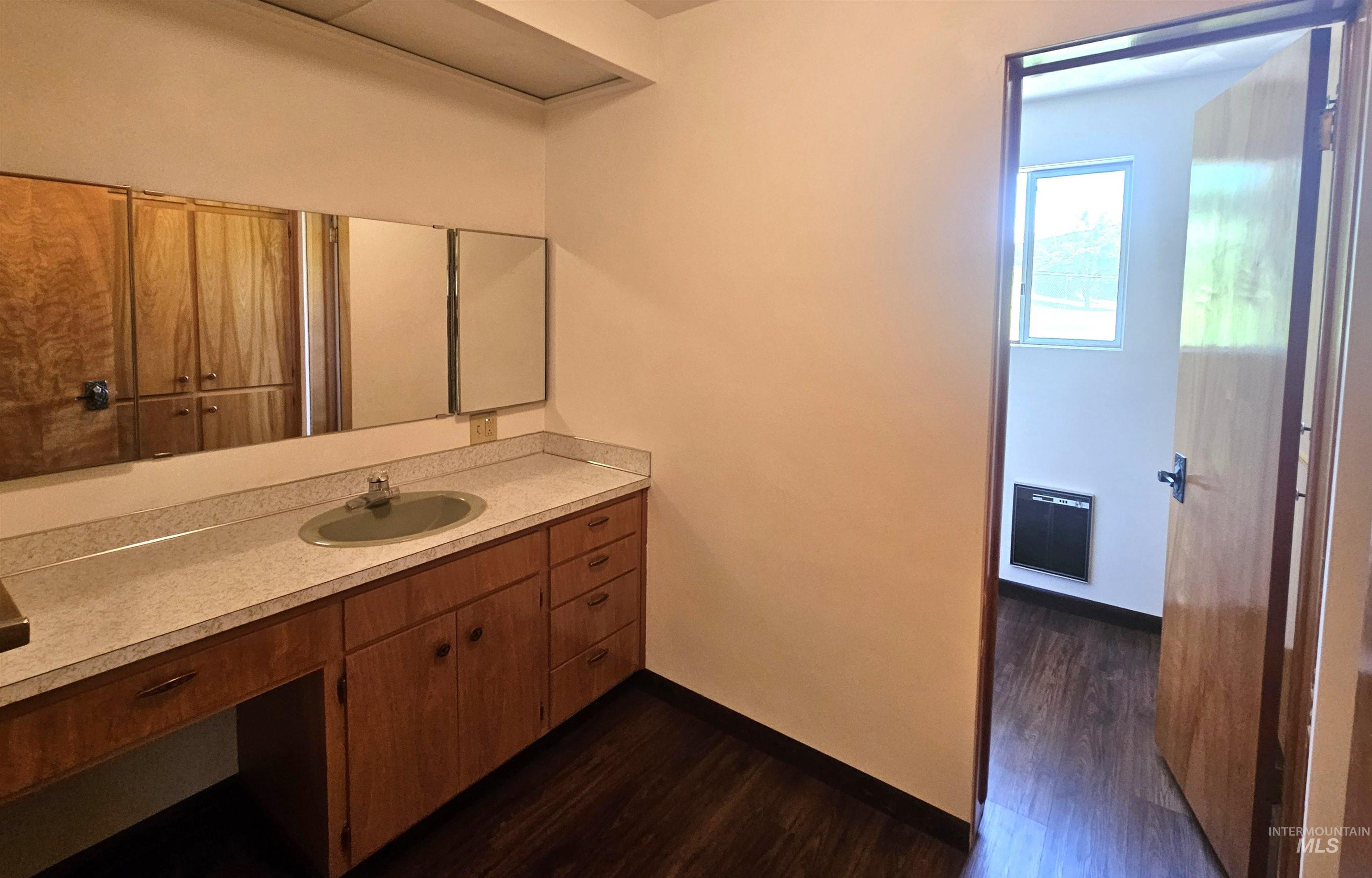 29865 Mission Creek Road Culdesac, ID 83524 - Photo 26 of 43 Bathroom vanity featuring a laminate countertop, integrated sink, and wood-finish cabinetry