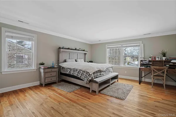 a bedroom with furniture and a wooden floor