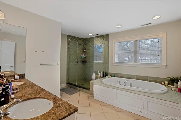 a bathroom with a granite countertop sink a toilet and shower