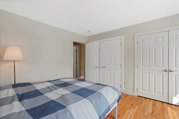 a bedroom with a bed and a lamp on table