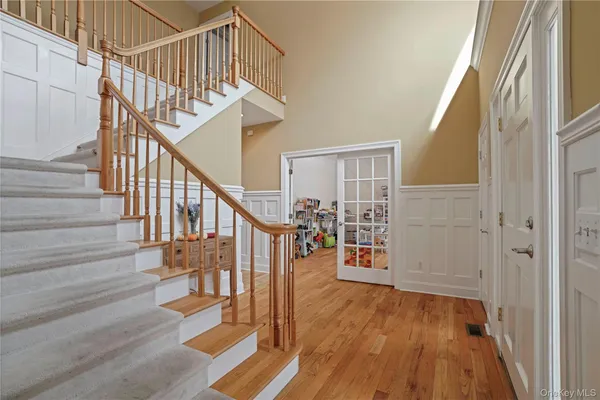 a view of entryway and hall with wooden floor