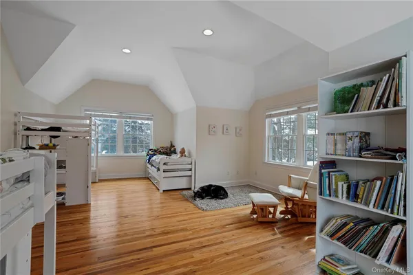 a living room with furniture and a book shelf